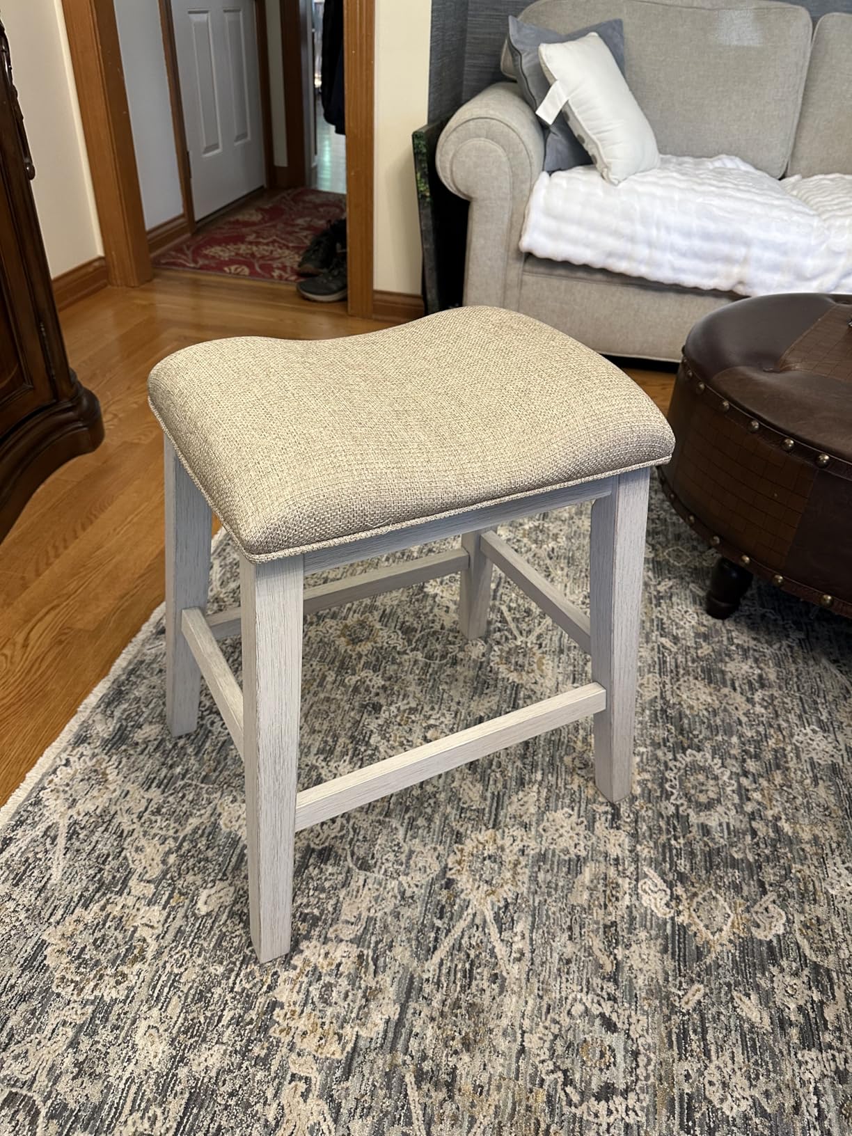 Signature Design by Ashley Skempton Counter Height Bar Stool, Set of 2 | Space-saving 24-inch farmhouse design, Supportive 18.5-inch foam-cushioned saddle seat, Distressed wood frame with footrest customer photo 1